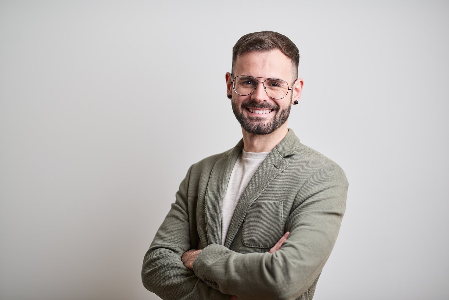 Business headshot, portrait looking at camera on gray background.